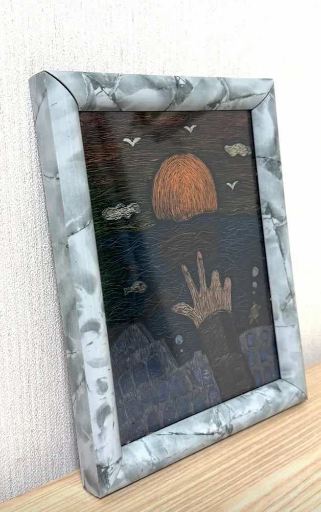 Framed scratch art of a hand reaching up through the sea toward an orange sun